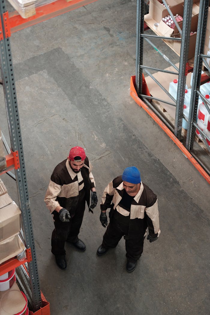 services-01 Two workers in a warehouse discussing logistics in an industrial setting